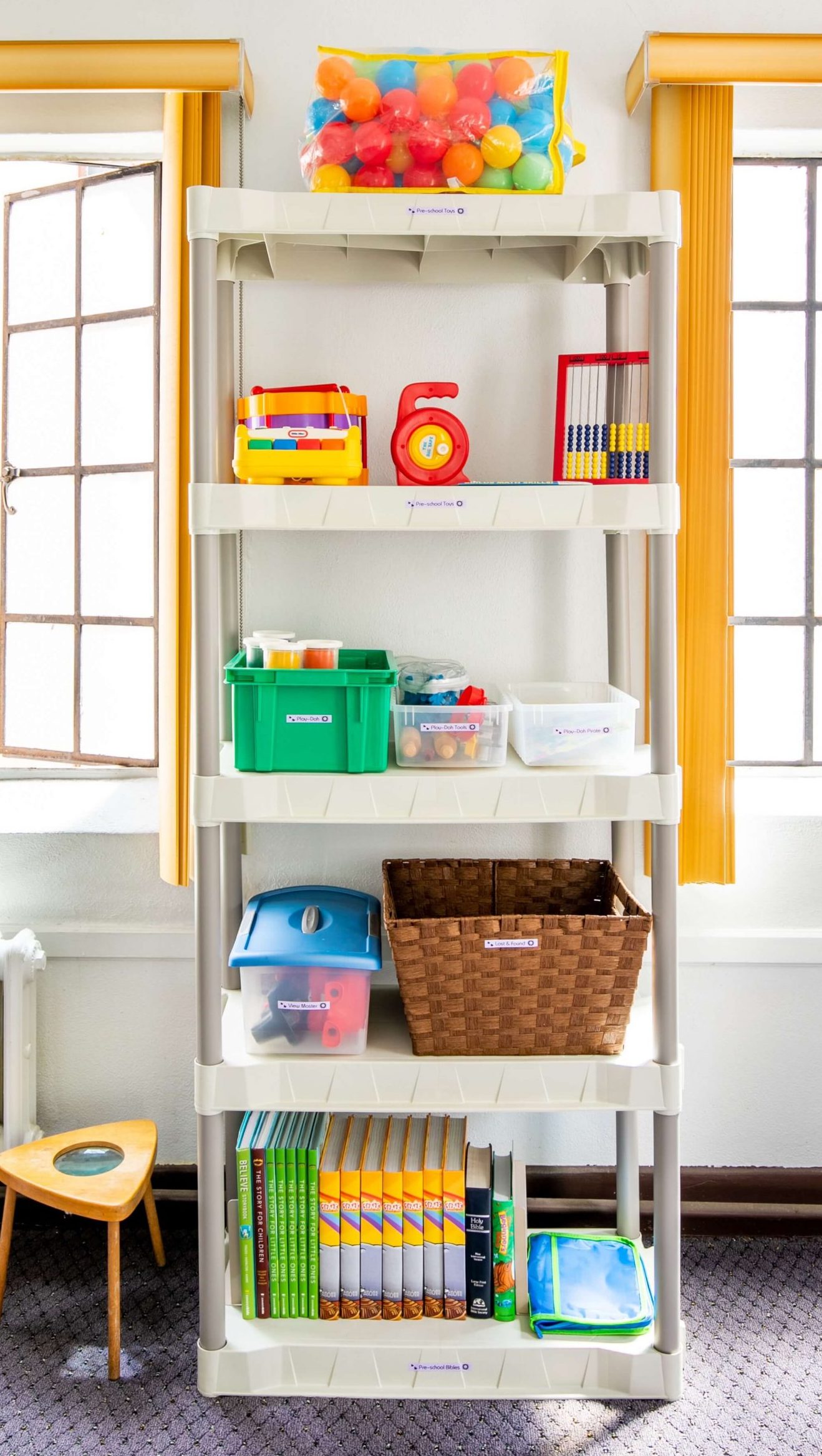 Melinda Grace Organizing of kids toys and supplies with baskets bins and labels on shelving