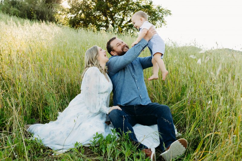 Melinda Grace and Family outside on a hill