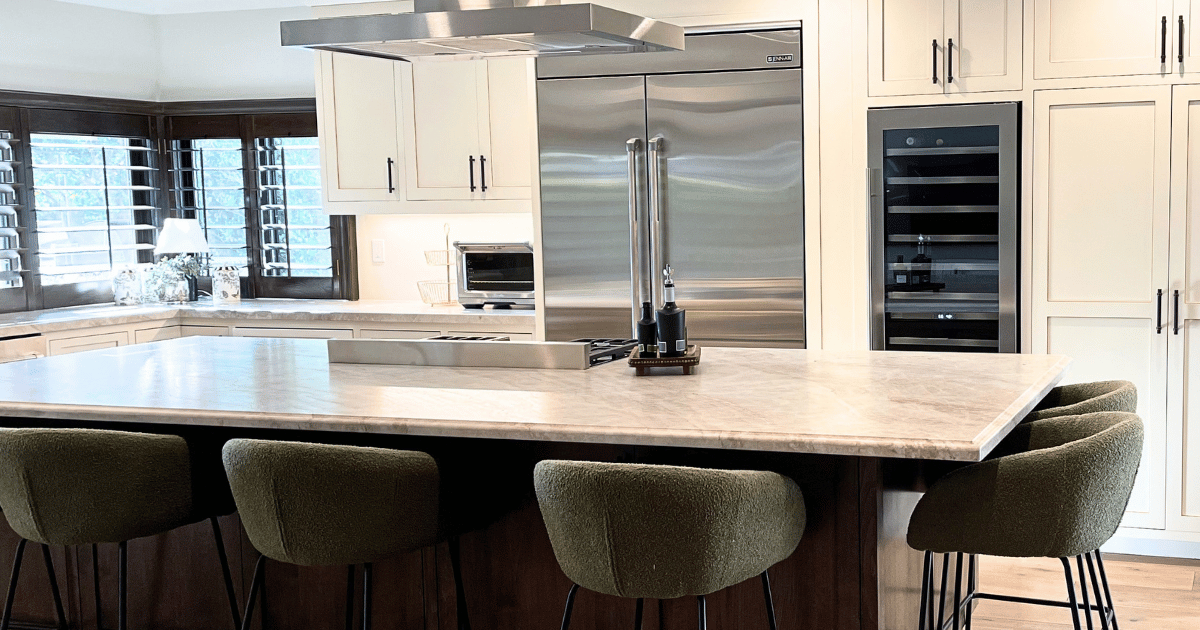 A luxury kitchen with a marble island and bouclé stools, beautifully organized by luxury home organizer Melinda Grace in Westlake Village.